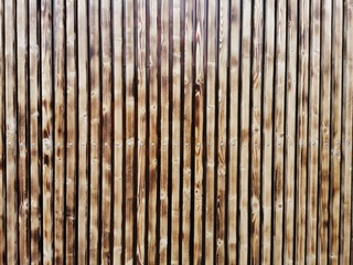 Wooden thin slats with traces of firing. Thin vertical slats.Wooden background.