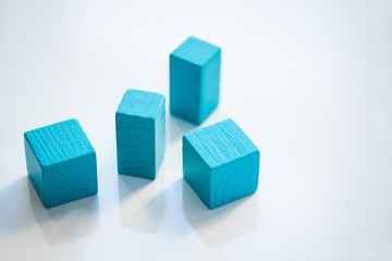 Group of blue flat wooden bricks and cubes standing in random order