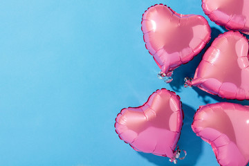 Air balloons heart shape on a blue background. Natural light. Banner. Concept love, wedding, photo zone. Flat lay, top view