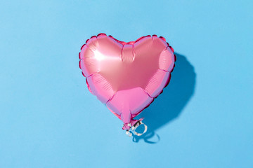 Air balloon heart shape on a blue background. Natural light. Banner. Concept love, wedding, photo zone. Flat lay, top view