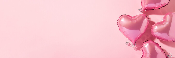 Air balloons heart shape on a pink background. Natural light. Banner. Concept love, wedding, photo...