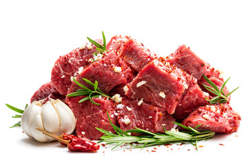 Sliced raw beef with rosemary herb and garlic isolated on white
