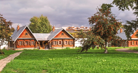 Fototapeta na wymiar Timbered village huts on green lawn