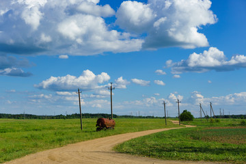 Rural road with rusty tank