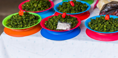 Green nama in plates at the local market, Fiji. Copy space for text.