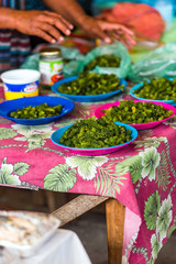 Green nama in plates at the local market, Fiji. Vertical.