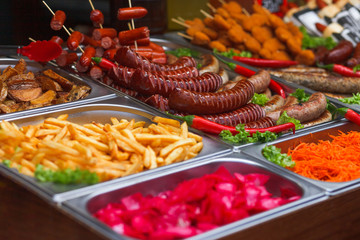 Various food at the annual christmas fair. Fried sausages, french fries and other tasty food