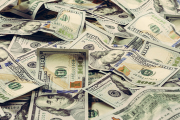 Dollar notes are lined up on a table close-up, a texture of dollar bill.