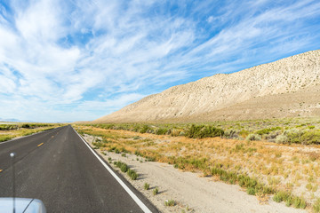 Traveling down the road in the desert hanging out the car window