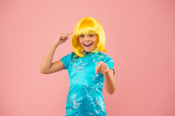 festival day in Japan. small girl pointing fonger on wig. asian girl yellow hair wig. chinese carnival. happy kid in chinese dress. Portrait of cute girl. japanese kimono. child costume of japan