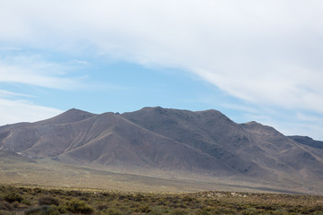 Beautiful white clouds against a vivid blue sky and a low mountain range