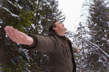 happy man breathing fresh air in the forest during a walk