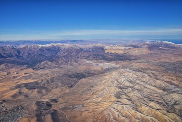 Fototapeta na wymiar Rocky Mountains, Oquirrh range aerial views, Wasatch Front Rock from airplane. South Jordan, West Valley, Magna and Herriman, by the Great Salt Lake Utah. United States of America. USA.