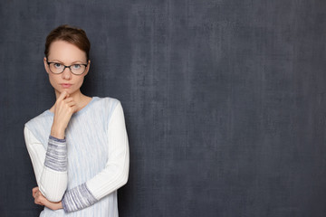 Portrait of serious thoughtful focused girl with glasses