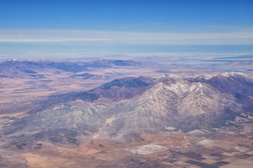 Fototapeta na wymiar Rocky Mountains, Oquirrh range aerial views, Wasatch Front Rock from airplane. South Jordan, West Valley, Magna and Herriman, by the Great Salt Lake Utah. United States of America. USA.