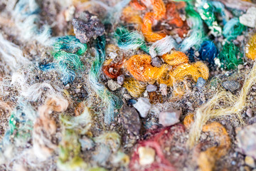 Thick multicolored carpet fibers worn to shreds