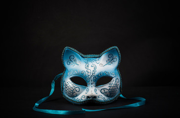 Coloured cat-shaped carnival mask for a celebration in a secluded background