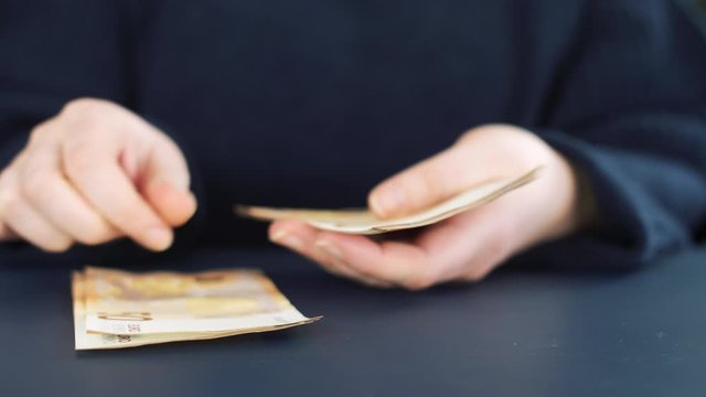 Close up of counting money. Nominal of 50 euro notes counting. Business bills money. Tax day or getting a paycheck for work. 4k slow motion footage.