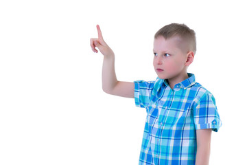 The boy points a finger at something.