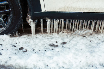 close up photo off car in iciles, a lot of water and snow, seasonal issues concept