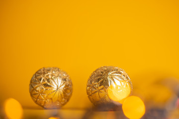 Yellow, red and purple christmas balls and garland lights. Selective focus.