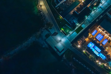 Aerial top view of Cyprus illuminated promenade at night with seaside, mediterranean tourist resort. Travel to Cyprus concept