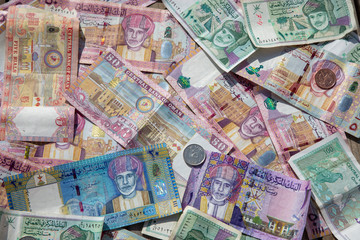 Closeup view of different banknotes and coins of omani rials