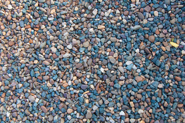 Multicolored small rocks, natural abstract stone texture or background