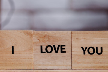 Wooden block with description: I love you on white background, Copy space