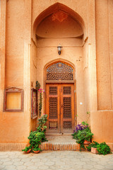 Fototapeta na wymiar Madrasah building in Yazd city, Iran. Typical oriental clay architecture 