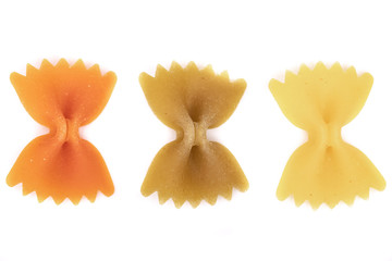 colorful Italian raw Pasta Farfalle three pieces laid out in a row. Close up. tricolour.white background.