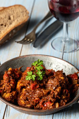 portion of austrian goulash on wood