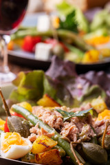 closeup of salade nicoise on dark wood