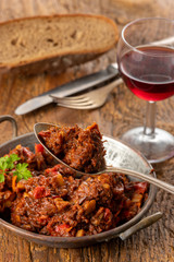 portion of austrian goulash on wood