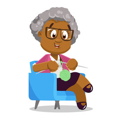 Afro-american silver haired elderly lady in pink blazer and skirt sitting in armchair.