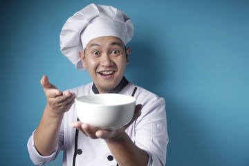 Asian Male Chef Shows Empty White Bowl, Presenting Something, Copy Space