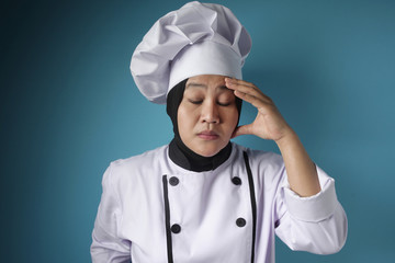 Female Asian Chef Suffers From Headache