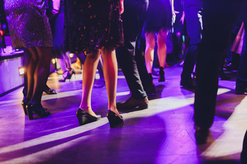 feet of people dancing on a club party. unrecognizable.