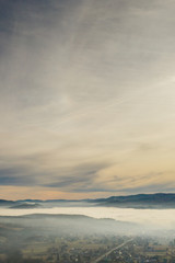 Fototapeta na wymiar Fog in mountains before sunrise, mountain valley with clouds. View to mountains of the Carpathians