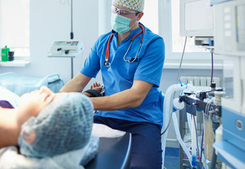 Man surgeon at work in operating room