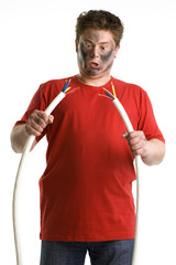 Shocked man holds two big cable. His fase is smoke black