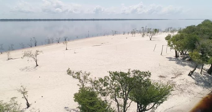 A white-sand beach on the Rio Negro, Anavilhanas National Park, in the Amazon rainforest. Tourist destination near the capital Manaus. Amazonas, Brazil.