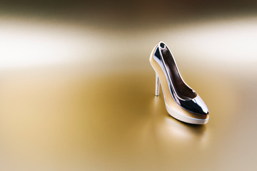 Gold high-heeled shoes