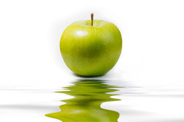 green apple and reflection on white background