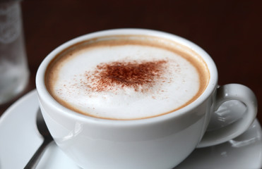 Close up hot cappuccino white coffee cup.