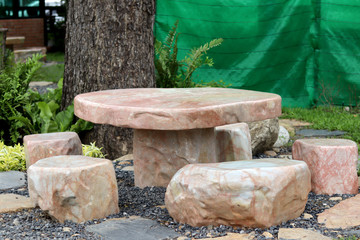 Marble stone bench set in the garden. Stone furniture.