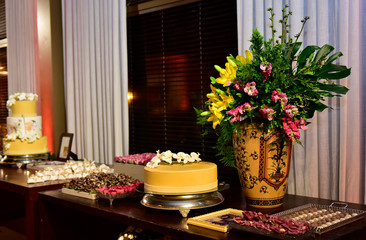 festive table setting with cake and flowers, party table with cake and sweets, condensed milk candy balls, candy balls, sweets table	