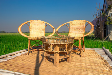 The blurred nature background of the green rice fields, and a seat to watch the scenery, a wooden...