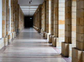 Long pass through many columns, effect of infinity. Architectural details of buildings.