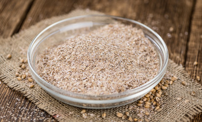 Portion of healthy Wheat Bran (selective focus; close-up shot)